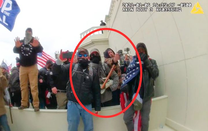 In this image from a Washington Metropolitan Police Department officer's body-worn video camera, released and annotated by the Justice Department in the Government's Sentencing Memorandum, Peter Schwartz circled in red is shown using a canister of pepper spray against officers on Jan. 6, 2021, in Washington. Schwartz on Friday, May 5, 2023, was sentenced to 14 years in prison for attacking police officers with pepper spray as he stormed the U.S. Capitol with his wife. (Justice Department via AP)