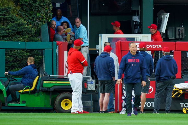 A fan, who fell into the Boston Red Sox bullpen, is brought down by the medical staff during the first inning of a baseball game against the Philadelphia Phillies on Friday.
