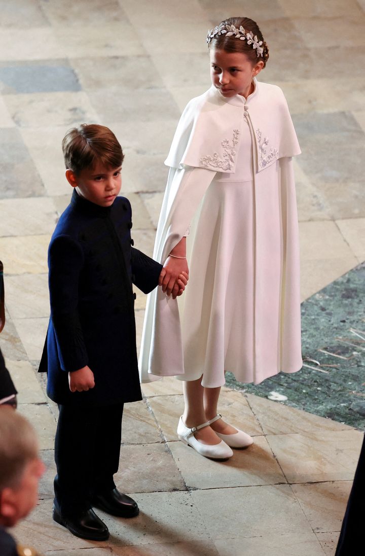 Charlotte and Louis hold hands as they enter Westminster Abbey. Their eldest brother, George, walked with King Charles, as he was one of the monarch's four Pages of Honour. 