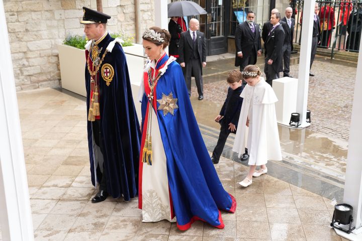 Louis and Charlotte walk behind their mom and dad as they enter Westminster Abbey. 