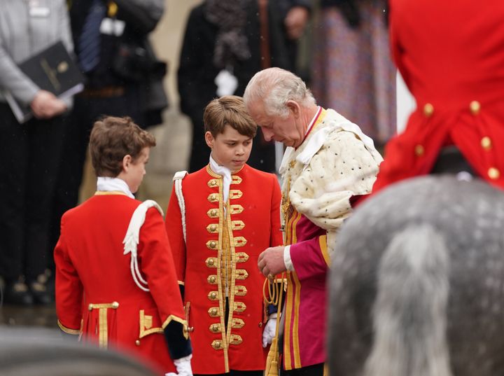 Prince George (center) and Charles outside Westminster Abbey.