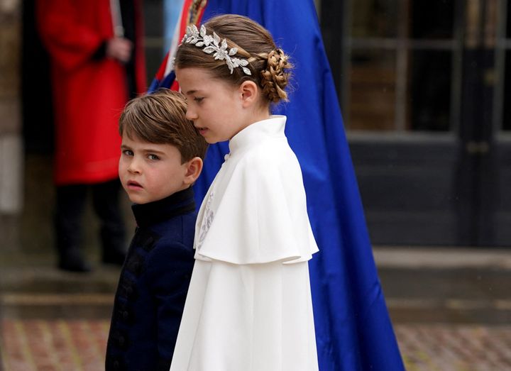 Prince Louis and Princess Charlotte walk into the Abbey together.