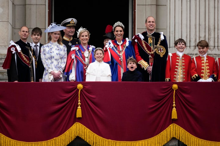 Louis makes another great face during the flypast over Buckingham Palace, as his brother George looks at him with a grin.