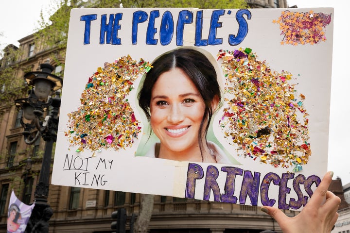 A member of the anti-monarchist group 'Republic' protest in Trafalgar Square with an image of Meghan, Duchess of Sussex.