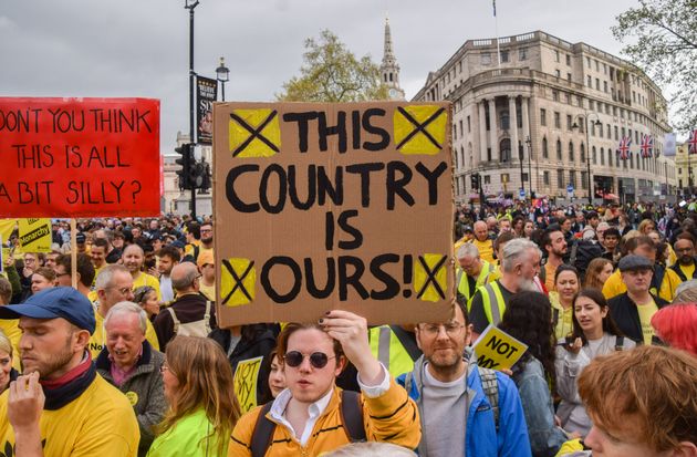 A protester holds a placard which states 'This country is ours' during the demonstration. 