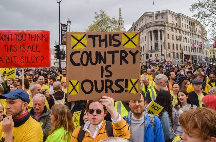 A protester holds a placard which states 'This country is ours' during the demonstration. 