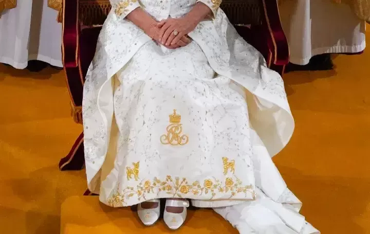 Beth and Bluebell got front-and-center placement just above the hem on Camilla's gold-embroidered gown.