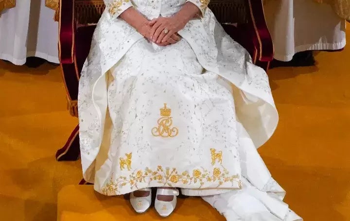 Beth and Bluebell got front-and-center placement just above the hem on Camilla's gold-embroidered gown.