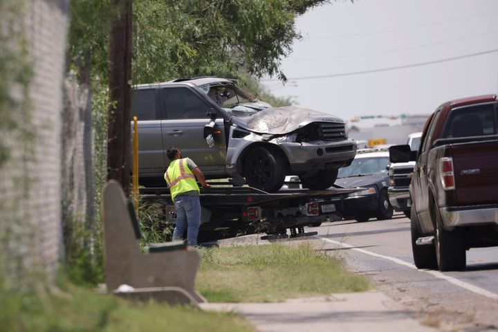 Emergency personnel take away a damaged vehicle after a fatal collision in Brownsville, Texas, on Sunday.