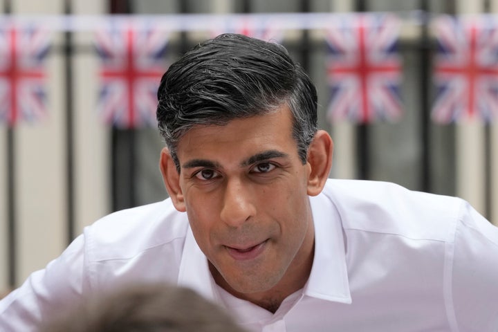 Rishi Sunak speaks to a guest as he attends the Big Lunch party at Downing Street on Sunday.