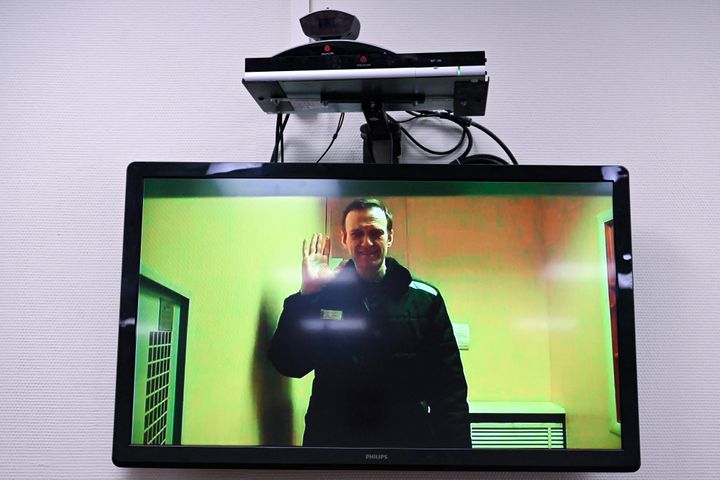Navalny is seen on a screen via a video link from his penal colony before a hearing over the extremism criminal case against him at the Basmanny district court in Moscow, April 26, 2023.