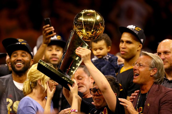 Nick Gilbert holds the championship trophy after Cleveland won the 2016 NBA Finals over the Golden State Warriors.