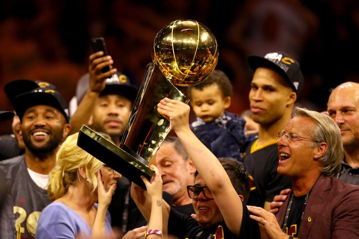 Nick Gilbert holds the championship trophy after Cleveland won the 2016 NBA Finals over the Golden State Warriors.