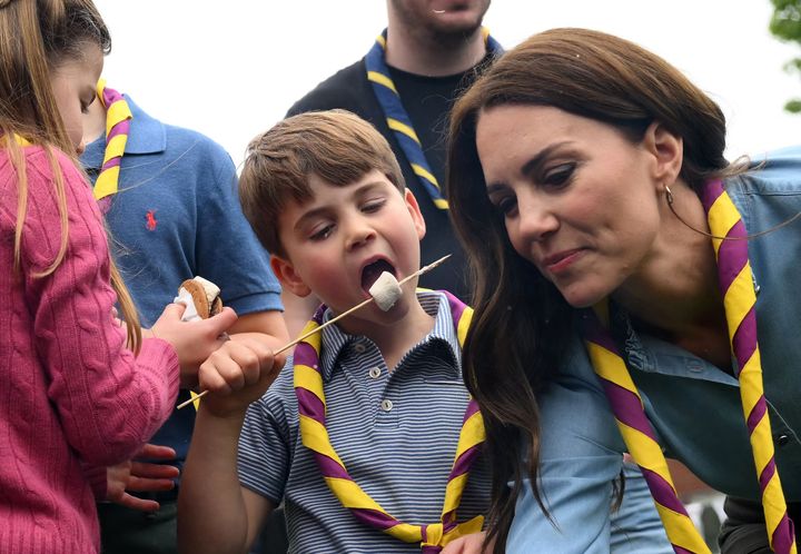 Prince Louis enjoys a toasted marshmallow as he takes part in the Big Help Out.