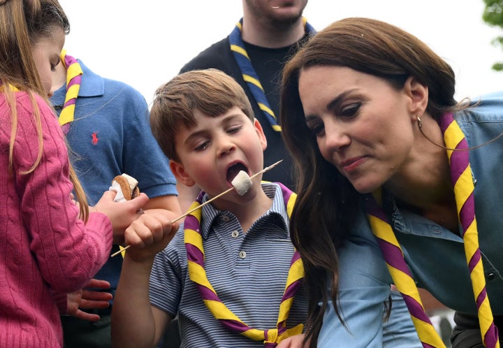 Prince Louis enjoys a toasted marshmallow as he takes part in the Big Help Out.