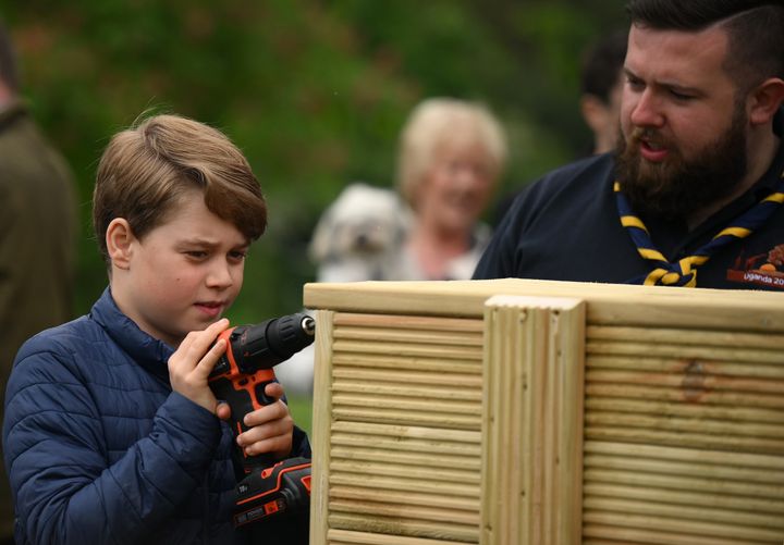 Prince George helps out with some woodwork as he joins his parents taking part in the Big Help Out.