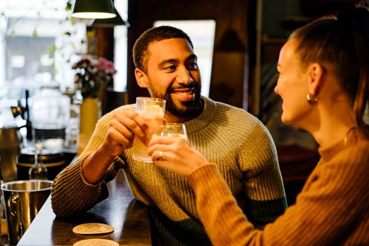 Afternoon date at bar with couple toasting each other