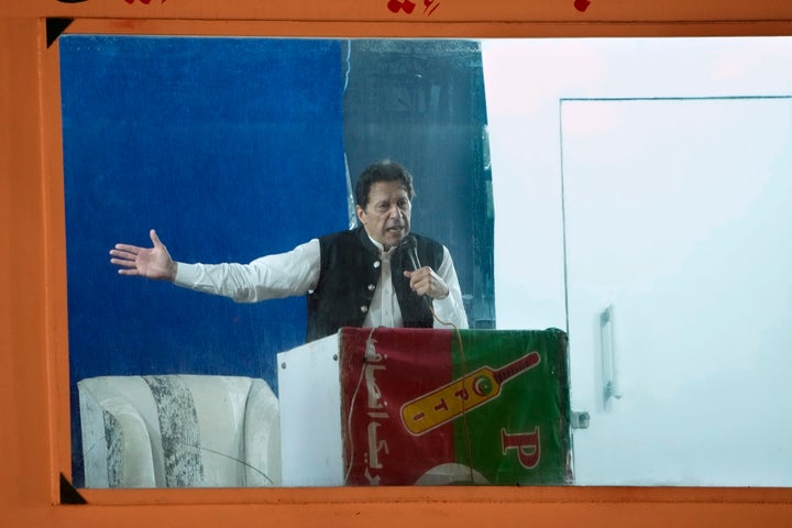 Protected by a bulletproof barrier, former Prime Minister Imran Khan speaks during a rally in Lahore, Pakistan, on March 26, 2023.