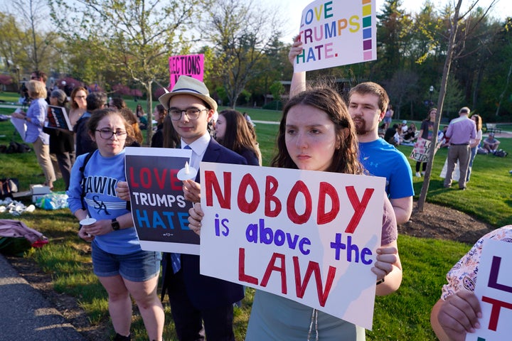 People protest outside a building on the campus of Saint Anselm College where a CNN televised town hall gathering with former President Donald Trump was held on May 10, 2023, in Manchester, New Hampshire.