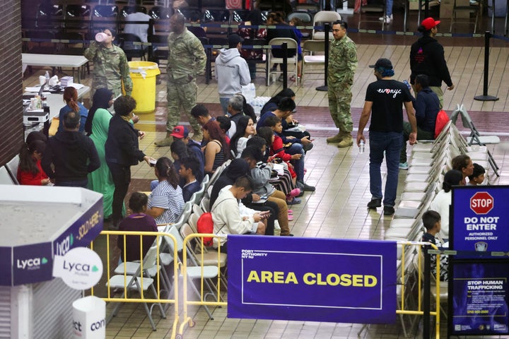 Migrants are seen at a bus terminal in New York City on Wednesday after being bused to the city from Texas. 