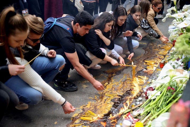 Scores of Serbian students on Thursday, May 4, 2023 paid silent homage to their peers killed a day earlier when a 13-year-old boy used his father’s guns in a school shooting rampage that sent shock waves through the nation and triggered moves to boost gun control. (AP Photo/Armin Durgut)