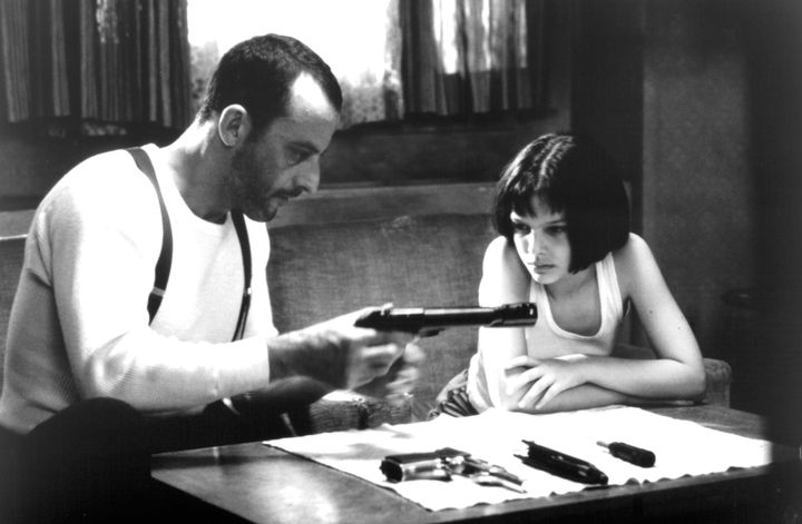 Jean Reno loads a gun in front of Natalie Portman in a scene from the film 'Léon: The Professional', 1994. (Photo by Columbia Pictures/Getty Images)