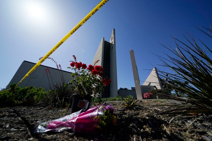 FILE - Flowers sit near crime scene tape at Geneva Presbyterian Church, Tuesday, May 17, 2022, in Laguna Woods, Calif., after a fatal shooting at the church. 