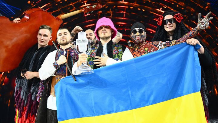 Members of the band "Kalush Orchestra" pose onstage with the winner's trophy and Ukraine's flags after winning on behalf of Ukraine the Eurovision Song contest 2022 on May 14, 2022.