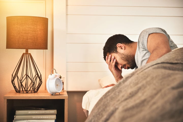 Young man struggling to sleep.