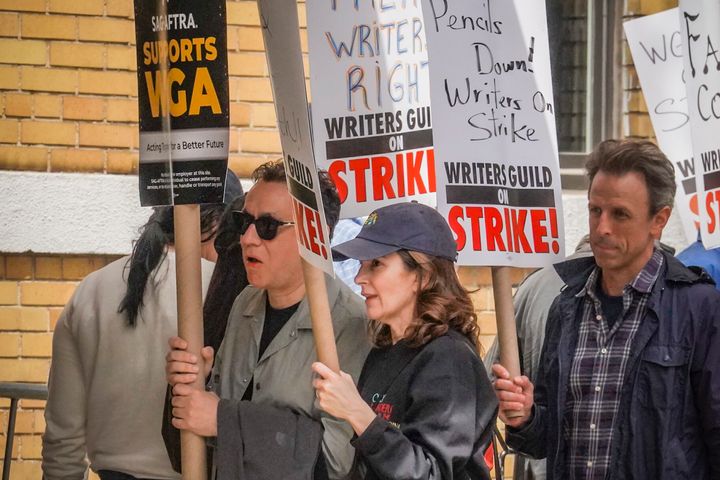 Actors and comedians Fred Armisen, Tina Fey and Seth Meyers join striking members of the Writers Guild of America on the picket line during a rally outside Silvercup Studios on Tuesday.