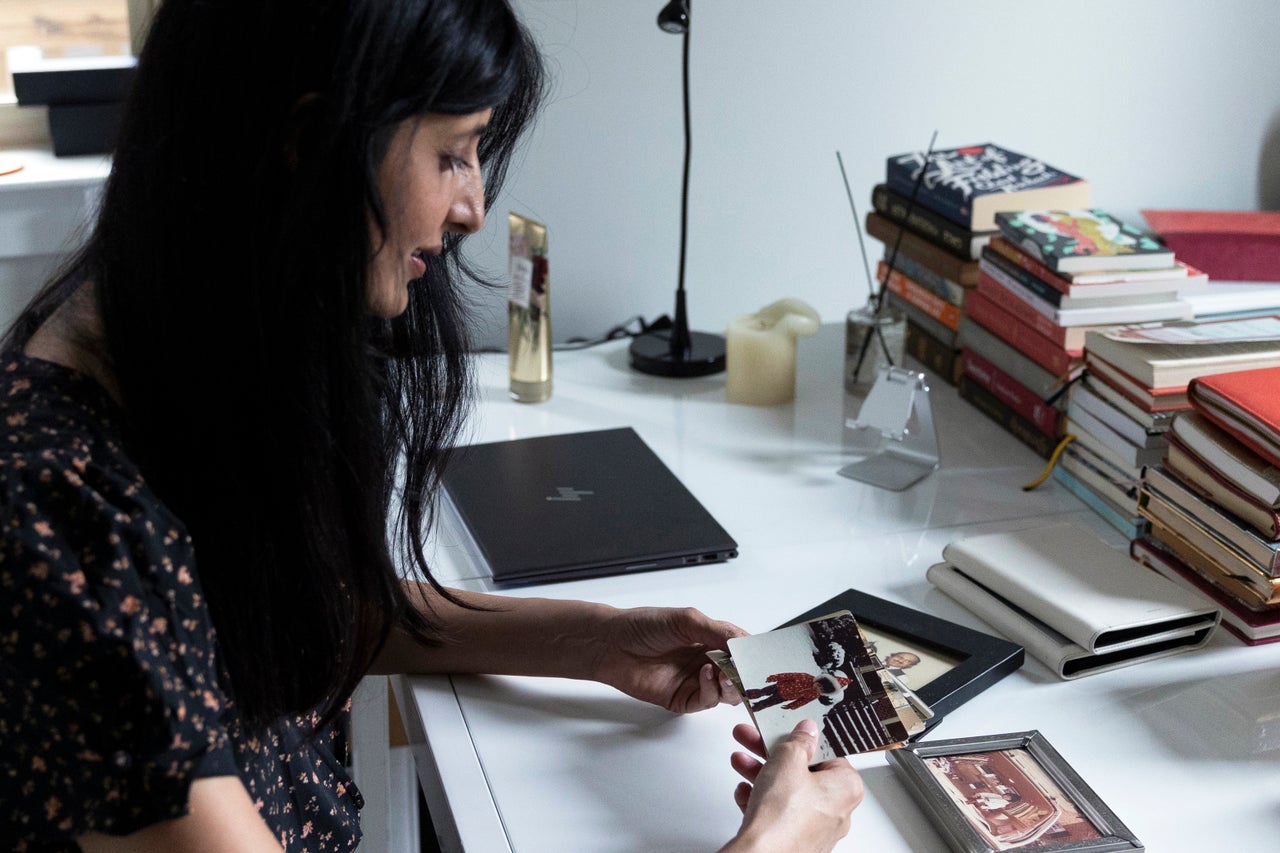 Treohan holds photographs of herself as a young girl.