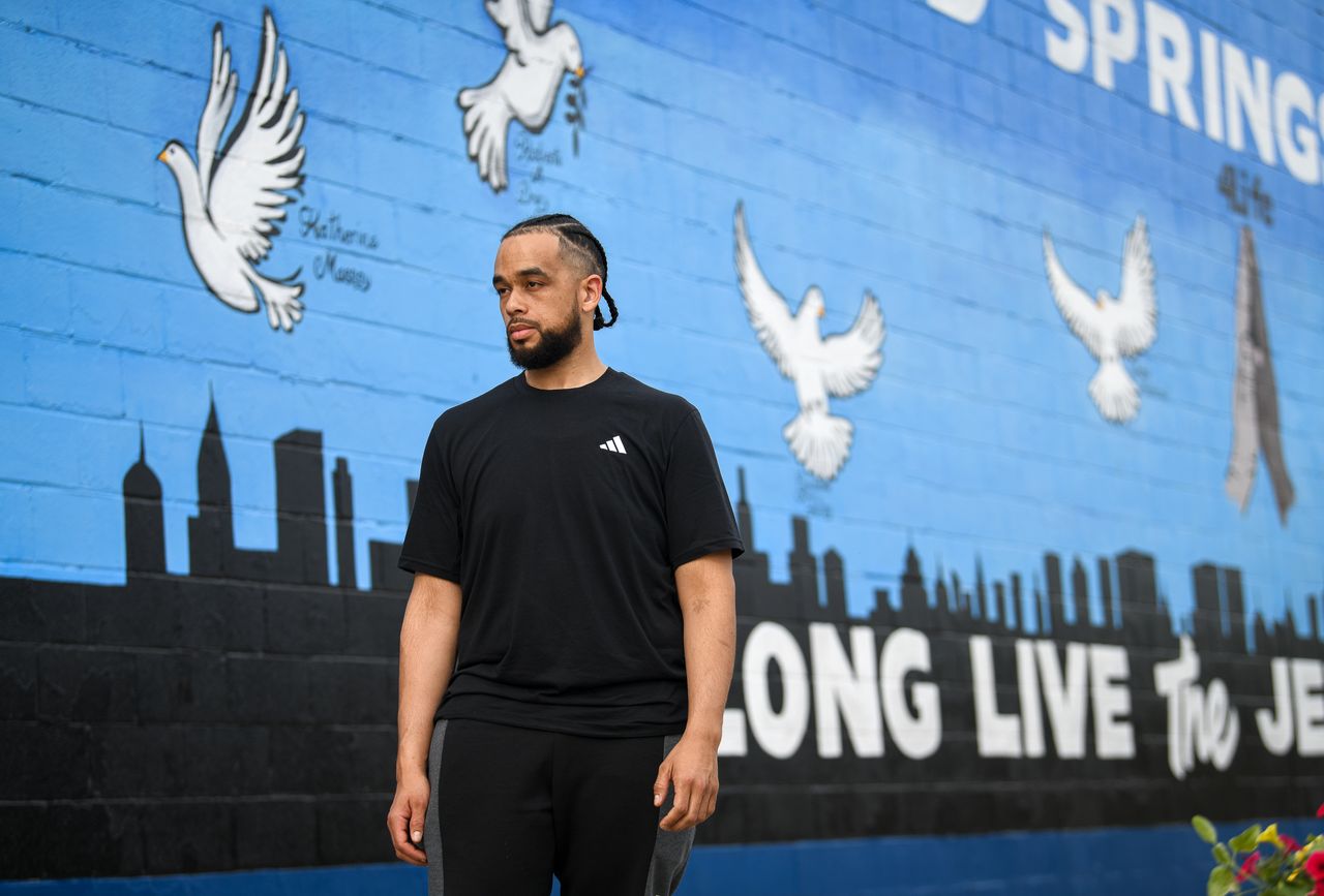Buffalo, N.Y., local activist, Myles Carter, stands in front of a memorial wall dedicated to the victims of the Tops supermarket massacre, located across the street from the supermarket in Buffalo, N.Y., Saturday, May 13, 2023.