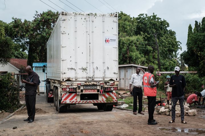 Members of the Kenyan Red Cross install a refrigerated container to store bodies removed on April 26 from a mass grave in the Shakahola forest, in the coastal county of Kilifi.