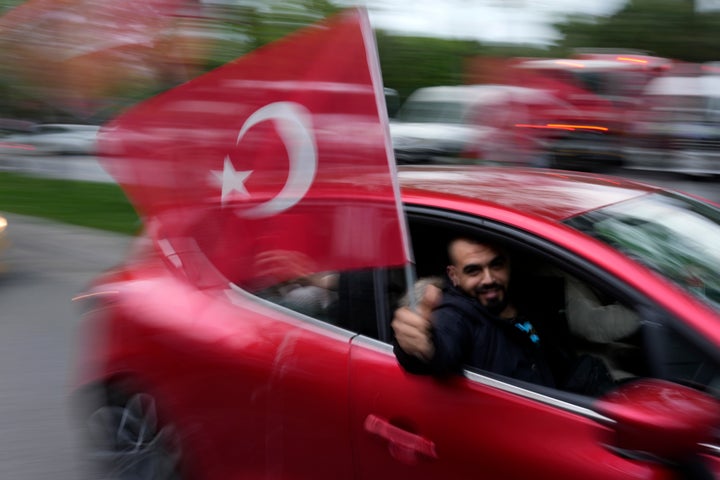 Supporters of President Recep Tayyip Erdogan cheer outside the headquarters of AK Party in Istanbul, Turkey, Sunday, May 14, 2023. More than 64 million people, including 3.4 million overseas voters, were eligible to vote in the elections, which come the year the country will mark the centenary of its establishment as a republic — a modern, secular state born on the ashes of the Ottoman Empire. (AP Photo/Francisco Seco)