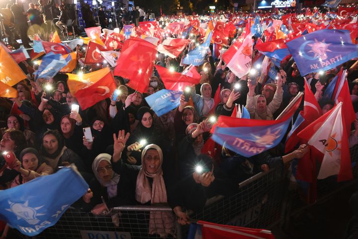 Supporters of Turkish President Tayyip Erdogan wave flags outside the AK Party headquarters after polls closed in Turkey's presidential and parliamentary elections in Ankara, Turkey May 15, 2023