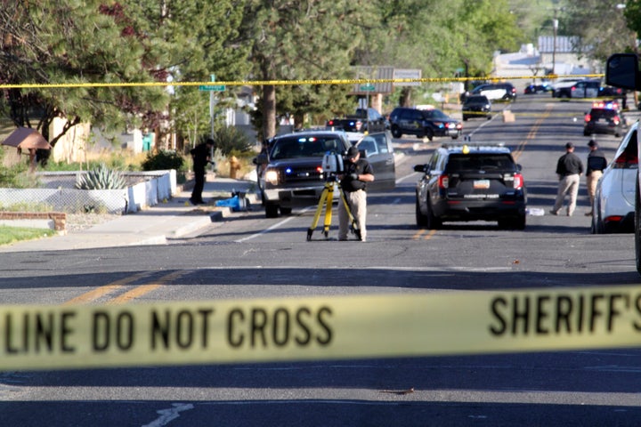 Investigators work along a residential street following a deadly shooting on May 15, 2023, in Farmington, N.M.