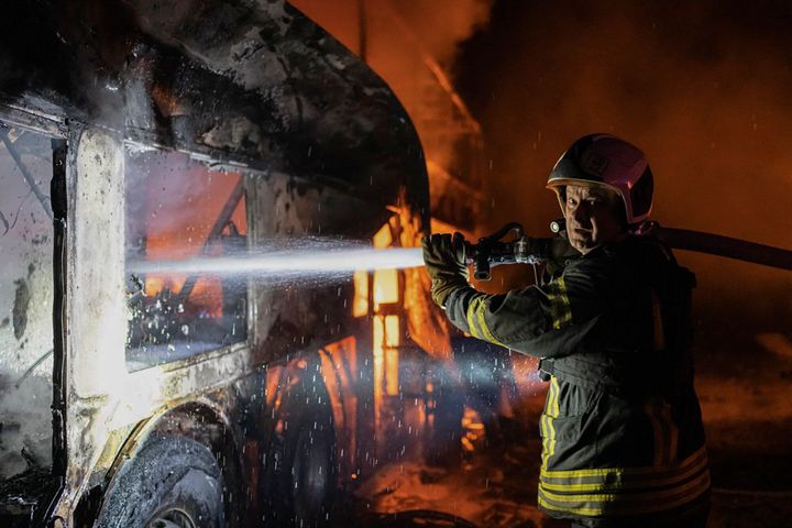 In this photo provided by the Ukrainian Emergency Situations Ministry, a firefighter tries to put out fire caused by fragments of a Russian rocket after it was shot down by air defense system during the night Russian rocket attack in Kyiv, Ukraine, on May 16, 2023.