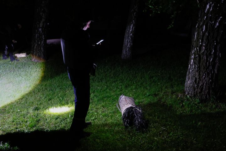 Police officers investigate fragments of a rocket that fell down in a city zoo after it was shot down by air defense system during the night in Kyiv, Ukraine, early May 16, 2023.