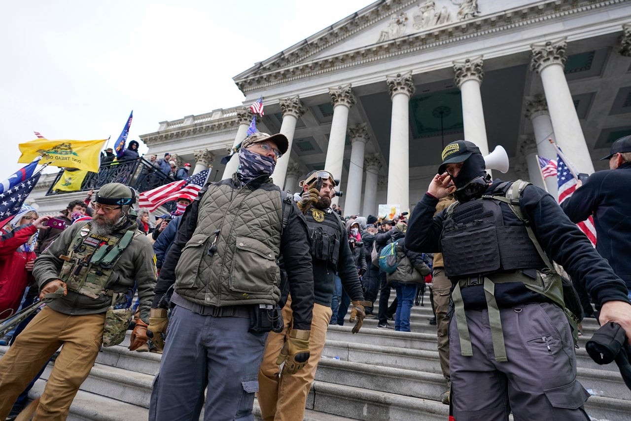 Members of the Oath Keepers extremist group stand on the East Front of the U.S. Capitol on Jan. 6, 2021.