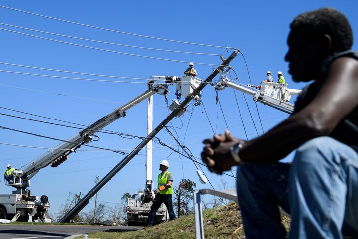 Utility workers repair power lines in the aftermath of Hurricane Michael in Panama City on Oct. 12, 2018.
