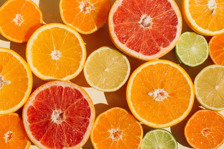 Pattern of slices citrus-fruit of Lemons, oranges, grapefruit, lime on beige background. Healthy food, diet and detox concept. Flat lay, top view