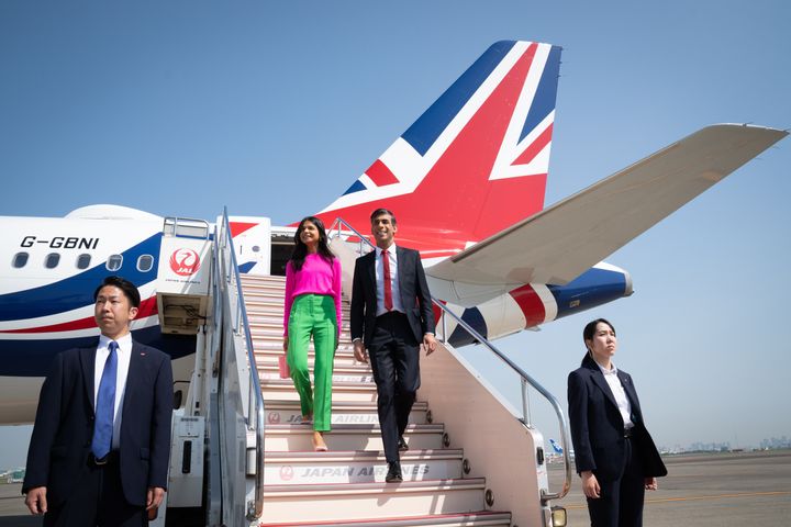 Rishi Sunak and his wife Akshata Murty disembark their plane as they arrive at Tokyo Airport ahead of the G7 Summit 