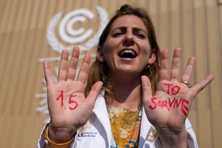 A demonstrator shows her hands reading "1.5 to survive" at a protest advocating for the warming goal at the Cop27 UN Climate Summit