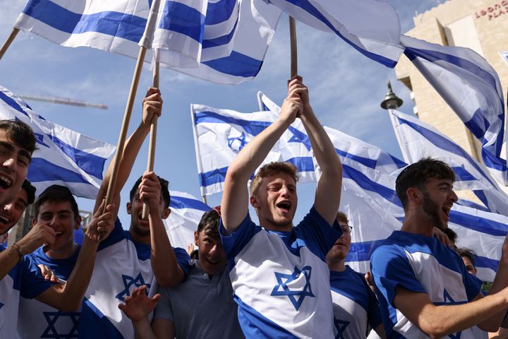 Israelis wave national flags during the annual 'flags march' to mark "Jerusalem Day", in Jerusalem on May 18, 2023. Jerusalem police and residents are bracing for extremist ministers and their supporters to rally on May 18 in an annual flag-waving march commemorating Israel's capture of the Old City.