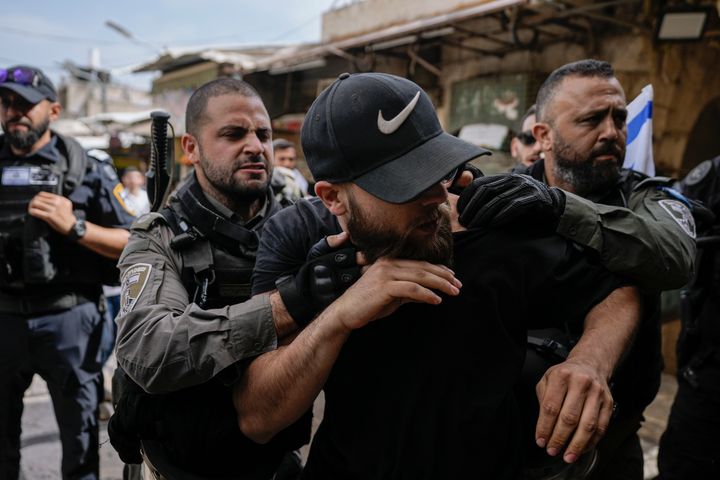 Israeli police push away Palestinians from a street in the Muslim Quarter of Jerusalem's Old City, shortly before a march through the area by Jewish nationalists, Thursday, May 18, 2023. The parade was marking Jerusalem Day, an Israeli holiday celebrating the capture of east Jerusalem in the 1967 Mideast war. Palestinians see the march as a provocation.
