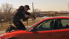 Iowa Police Officer Holds Onto Hood Of Car As Suspect Flees In Wild Video