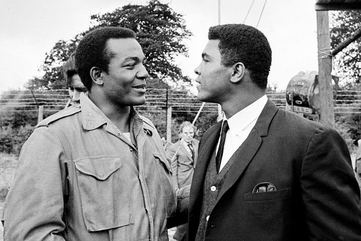 FILE - In this Aug. 5, 1966, file photo, heavyweight boxer Muhammad Ali, right, visits Cleveland Browns running back and actor Jim Brown on the film set of "The Dirty Dozen" at Morkyate, Bedfordshire, England. NFL legend, actor and social activist Jim Brown passed away peacefully in his Los Angeles home on Thursday night, May 18, 2023, with his wife, Monique, by his side, according to a spokeswoman for Brown's family. He was 87. (AP Photo/File)