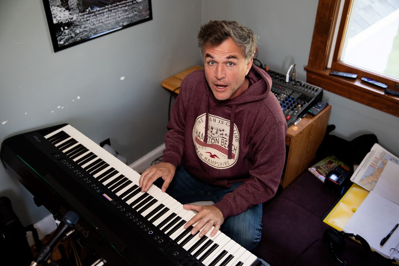 Farley poses for a portrait while sitting behind his piano on Wednesday in Danvers, Massachusetts. Farley, who has tens of thousands of songs to his name, saw his music go viral on TikTok earlier this month.