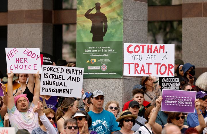 An abortion rights supporter's sign slams North Carolina state Rep. Tricia Cotham (R) as a "traitor."