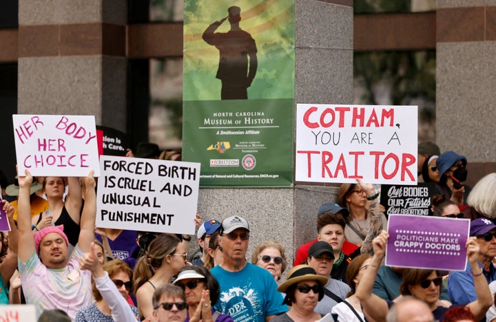 An abortion rights supporter's sign slams North Carolina state Rep. Tricia Cotham (R) as a "traitor."